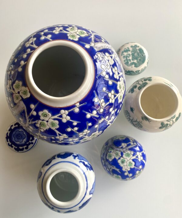 A collection of vintage lidded ginger jars in blue and white.