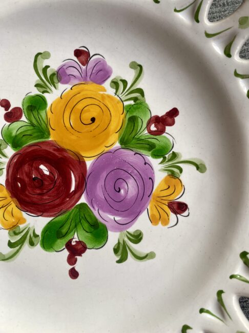 Detail of hand-painted florals on a pretty wall plate.