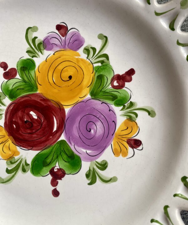 Detail of hand-painted florals on a pretty wall plate.