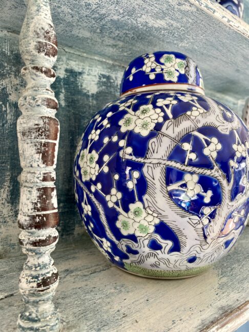 A pretty blue and white Chinese style pot with blossom tree detailing.