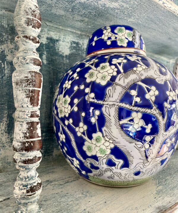 A pretty blue and white Chinese style pot with blossom tree detailing.