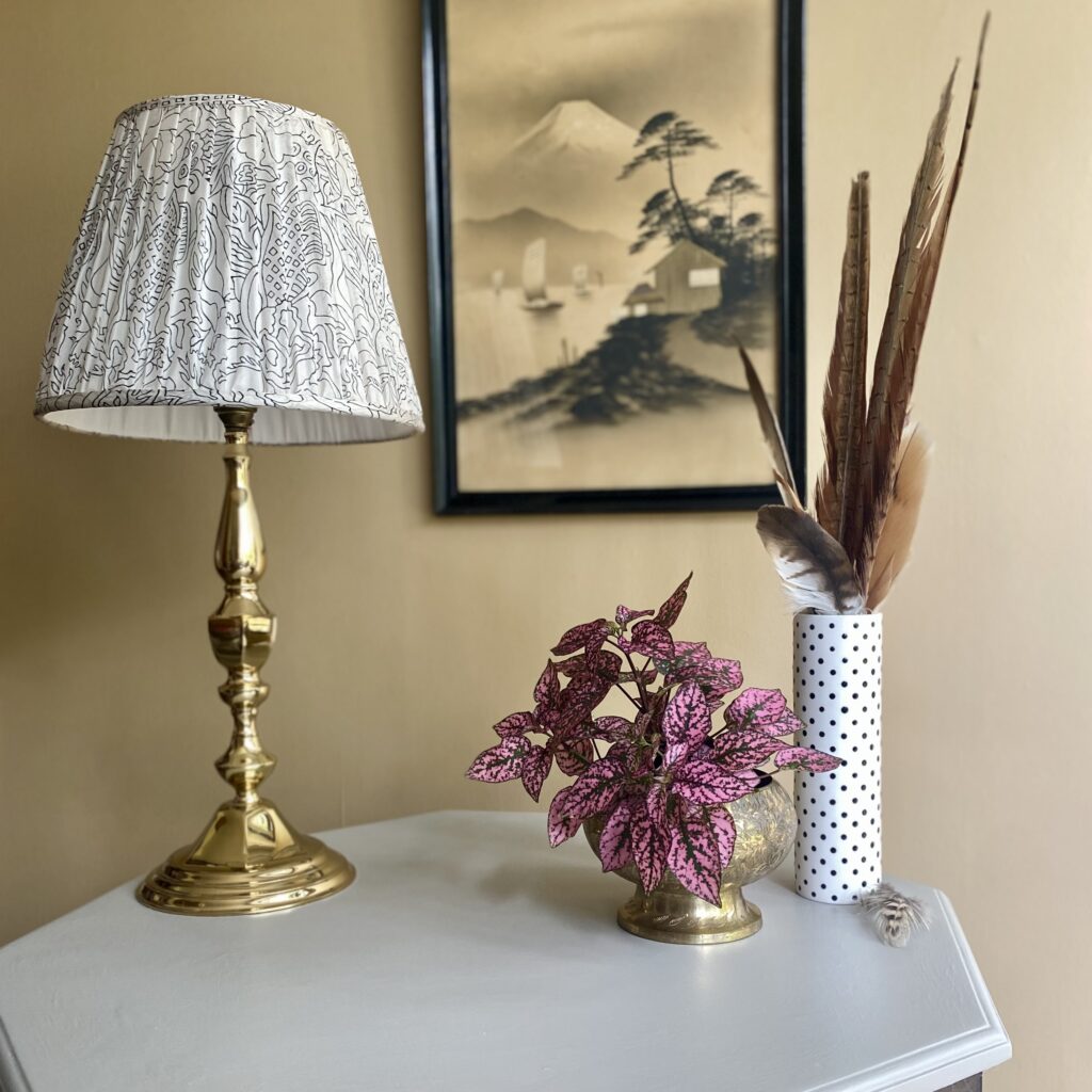 An interior vignette showcasing elegant neutrals in shades of warm grey, monochrome and vintage brass.