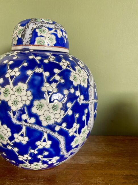 A blossom design china pot with lid.