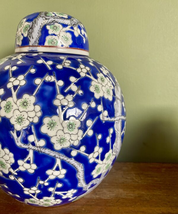 A blossom design china pot with lid.