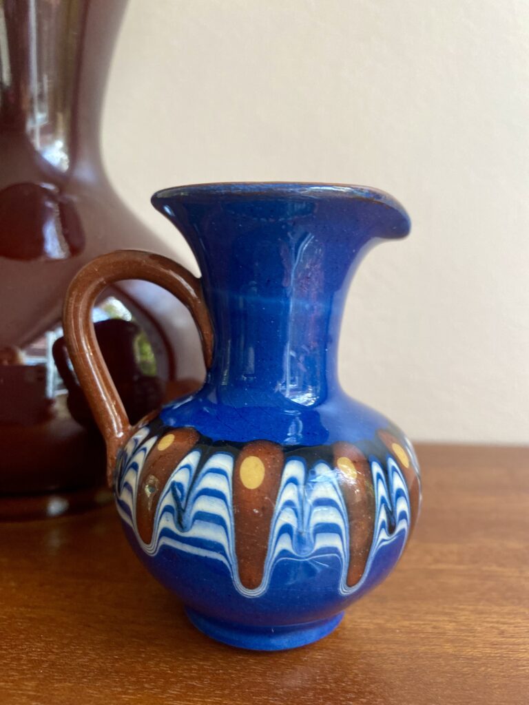 A miniature andmade pottery jug hailing from the Bulgarian Troyan tradition.