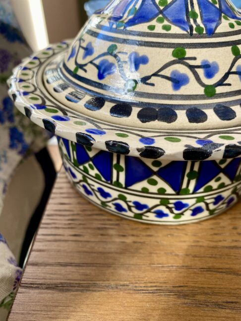 Close-up image of a blue and white hand-painted pot.