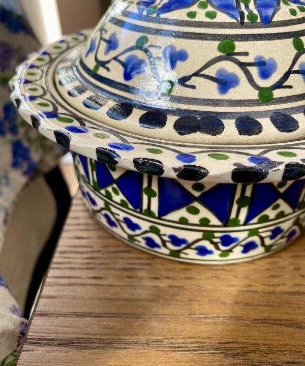 Close-up image of a blue and white hand-painted pot.