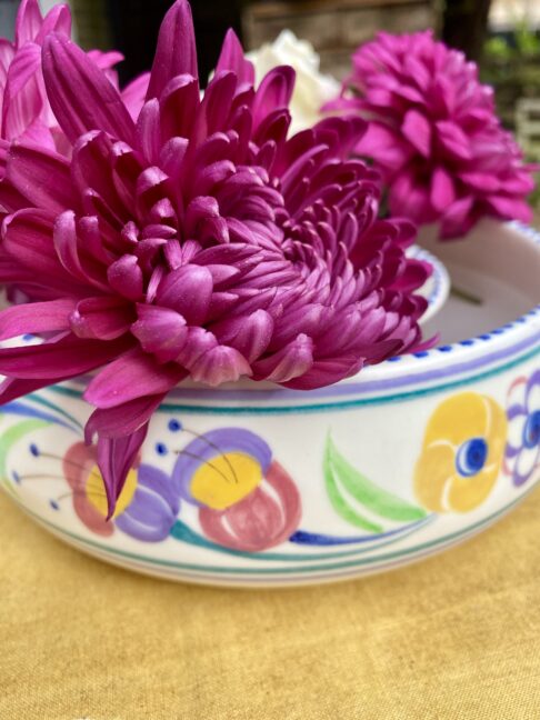 Pink dahlias in a Poole pottery posy ring.