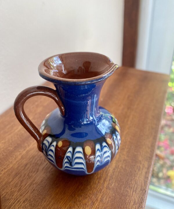 A diminutive, earthy-hued glazed clay jug from Bulgaria.