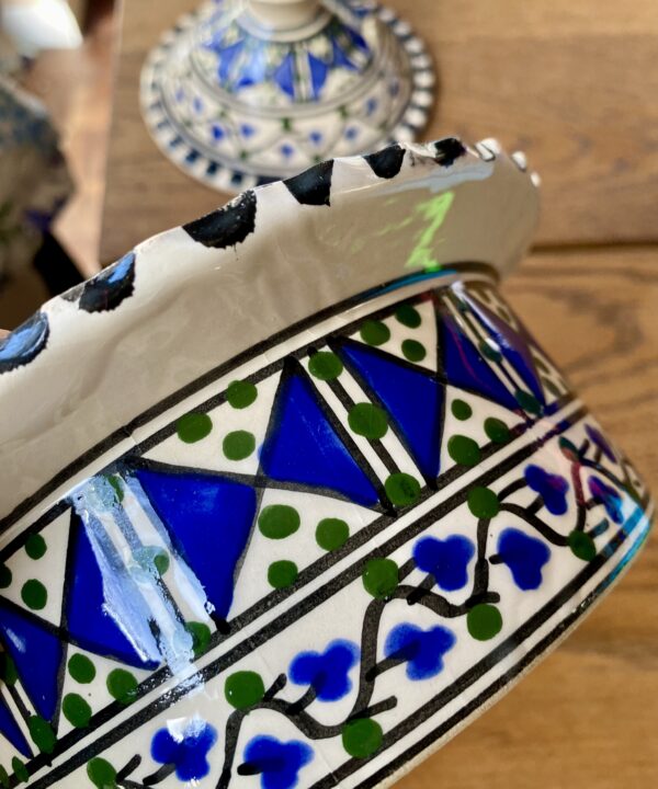 Bright blue and green hand-painted ceramic decoration.