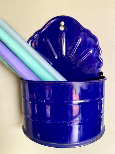 A French salt box in Royal blue enamel, filled with glossy dinner candles.