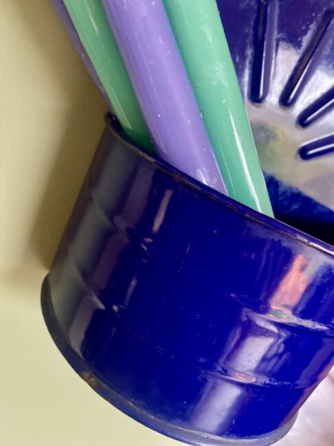 Detail of a vintage blue enamel salt box with candles.