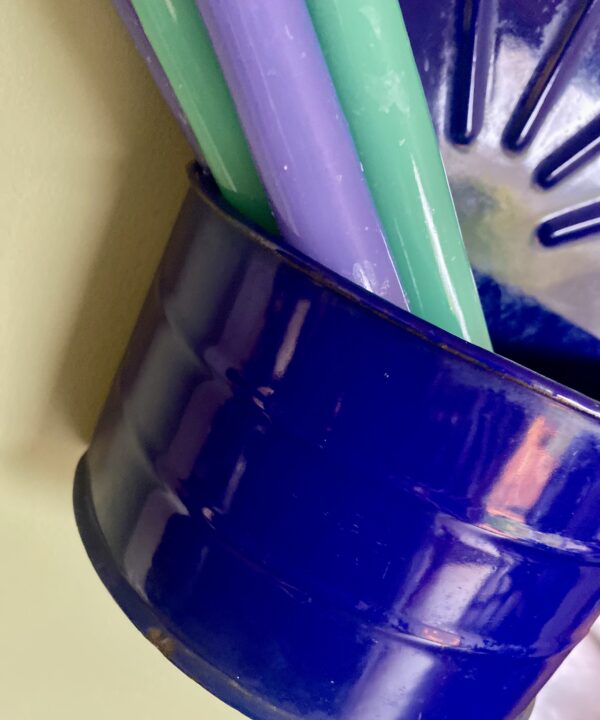 Detail of a vintage blue enamel salt box with candles.