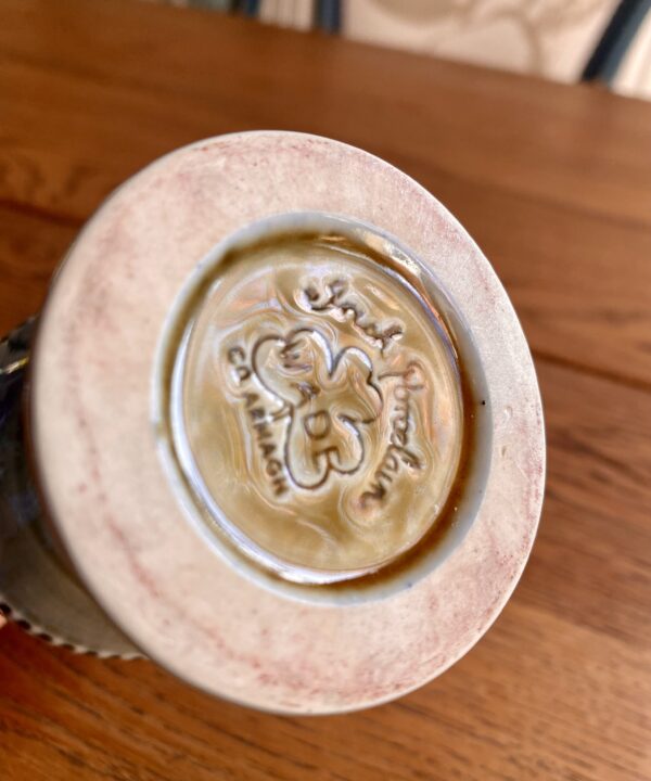 The back stamp on an Irish craft pottery showing a shamrock on a goblet by Wade.