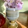 A vintage Irish pottery bud vase or goblet by Wade, filled with dusky pink hydrangea blooms.