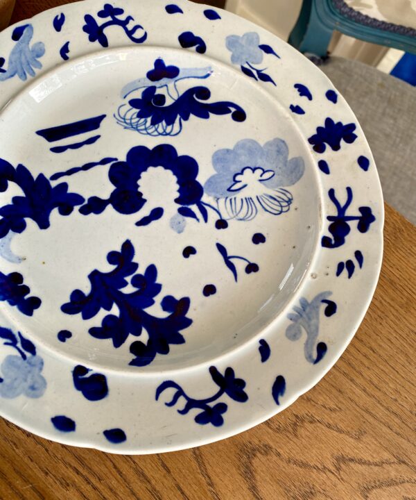 An antique plate in blues and whites dating from the late Georgian era and handmade in Staffordshire from pearlware.