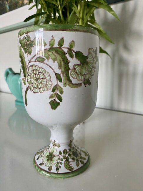 A footed vase handmade in Portugal with floral hand-painted decoration.