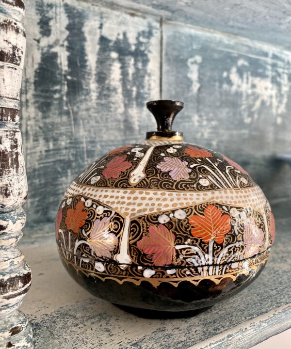 A vintage trinket pot with a domed lid, hand-painted in India.