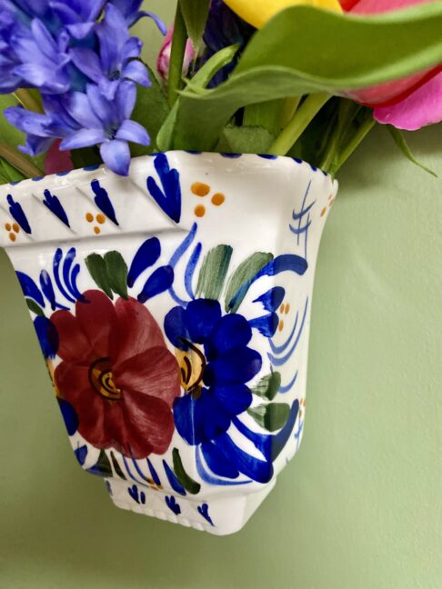 A handmade, artisanal wall vase painted by a Portuguese pottery artist.