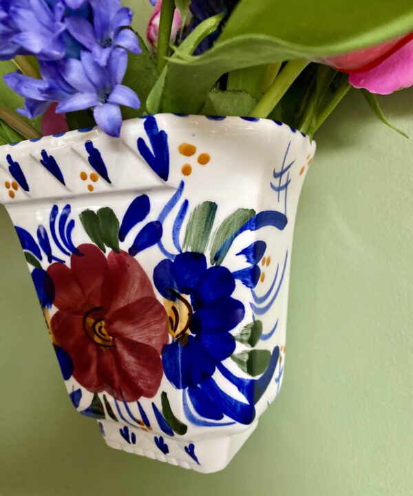 A handmade, artisanal wall vase painted by a Portuguese pottery artist.