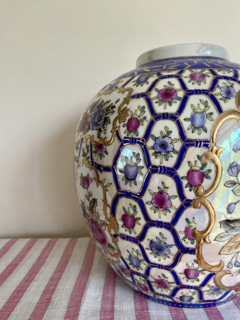 Decorative hand-painted, florals on a vintage Chinese pot.