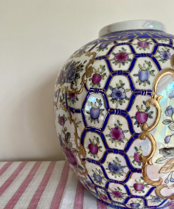 Decorative hand-painted, florals on a vintage Chinese pot.