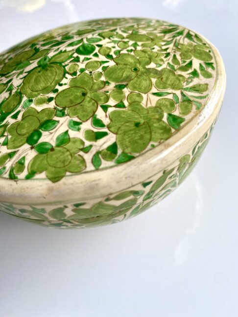 Detail of hand-painted decoration on a ring box or pretty storage pot.