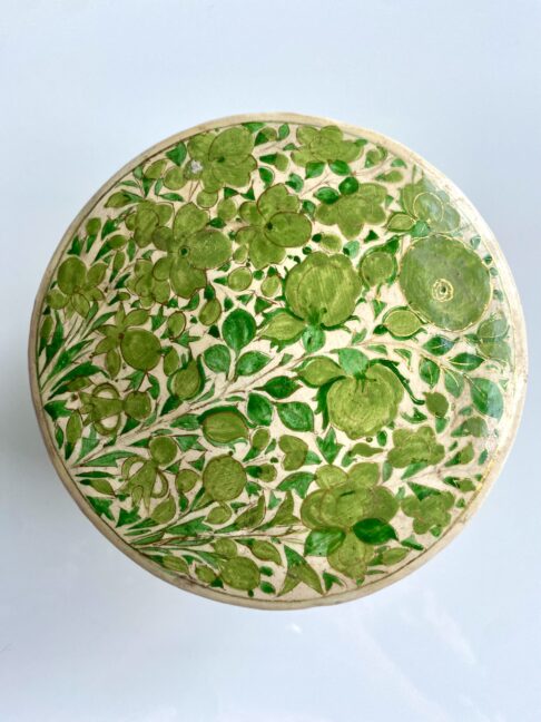 A gloriously pretty trinket pot in lime green decorated with flowers.