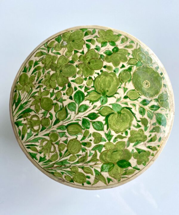 A gloriously pretty trinket pot in lime green decorated with flowers.