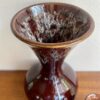 Honeycomb glaze detail on a brown, handmade. funnel-neck vase dating from the 1970s.