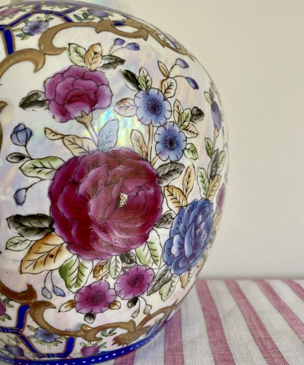 Hand-painted floral detail on a vintage Chinese vase.