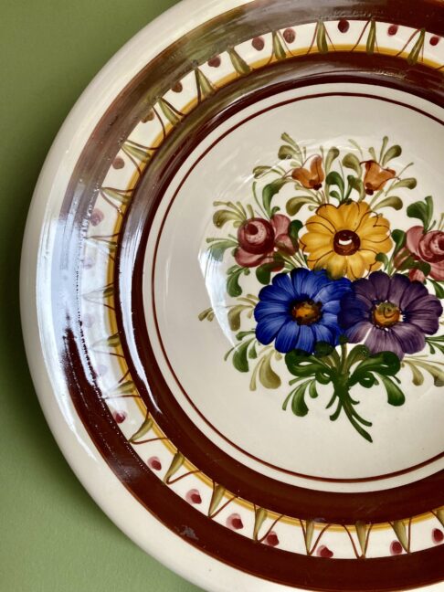 Wechsler vintage wall plate with floral design.