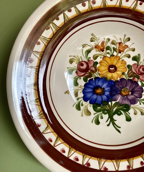 Wechsler vintage wall plate with floral design.