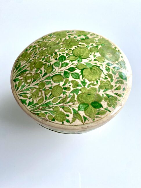 A dressing table storage pot for rings and knick-knacks. Hand-painted Indian décor in lime green.