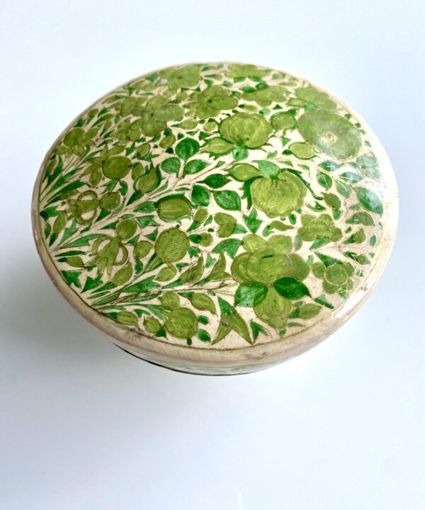 A dressing table storage pot for rings and knick-knacks. Hand-painted Indian décor in lime green.