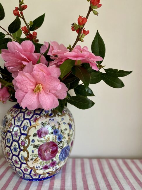 A pretty Chinese vase filled with seasonal pink blooms.