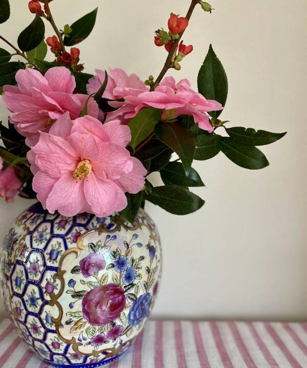 A pretty Chinese vase filled with seasonal pink blooms.