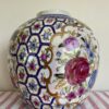 Vintage Chinese vase in pink with hand-painted rose design and florals with blue and gold-coloured accents.