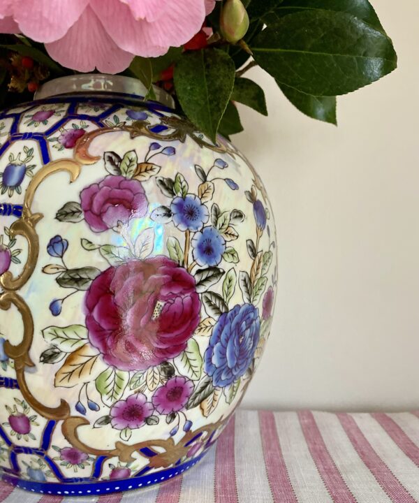 Pretty rose design on a vintage Chinese pot or vase in blue, pink and gold.