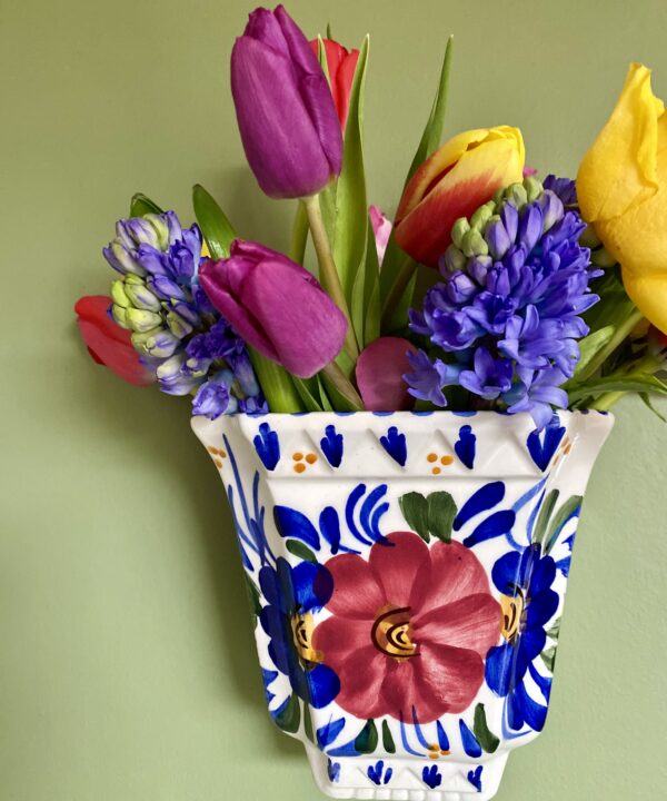 Pretty wall vase with flower design.