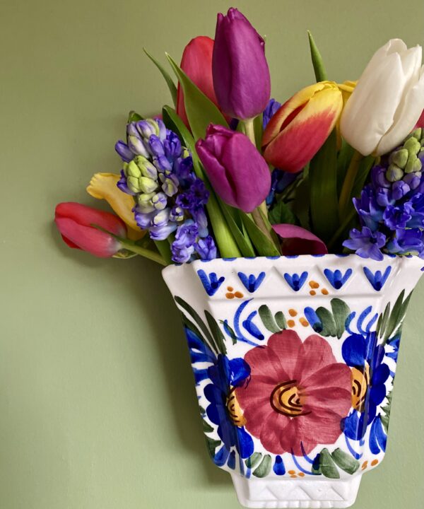 A pretty, vintage wall pocket for flowers.