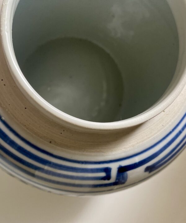 The rim of a vintage Chinese ginger jar with lid.