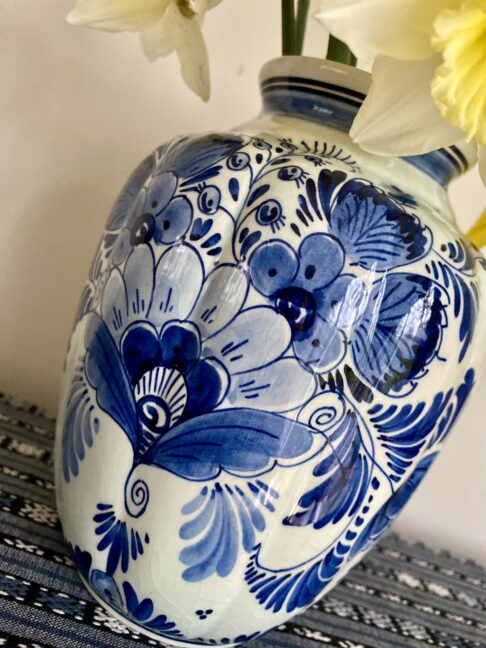 A floral vase with segmented shape and blue colouring.