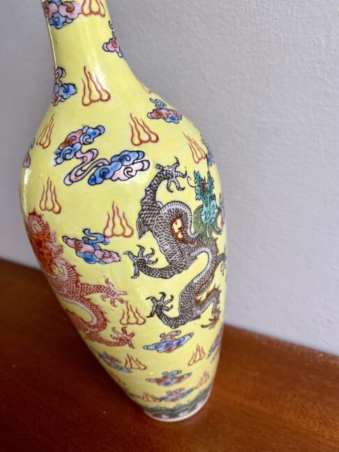 Intricate dragon motifs on a Chinese bottle vase.