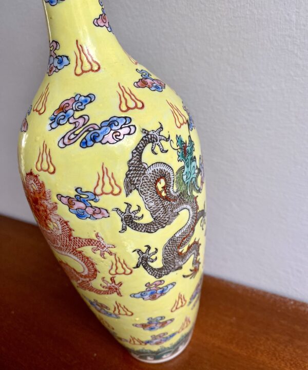 Intricate dragon motifs on a Chinese bottle vase.