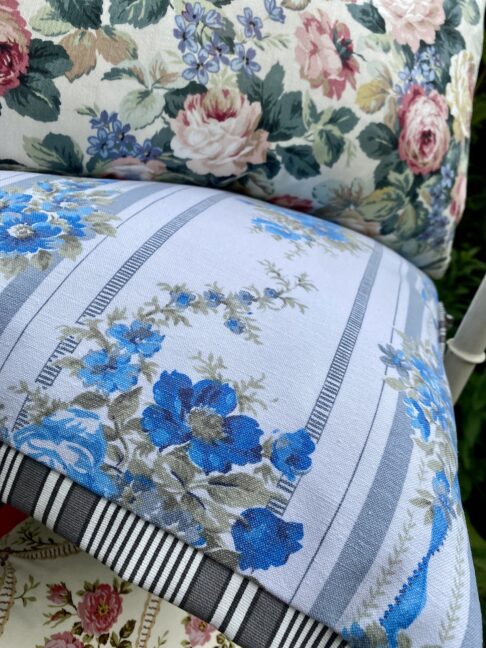 Vintage French floral cushions with a grey, black and white striped Oxford trim.