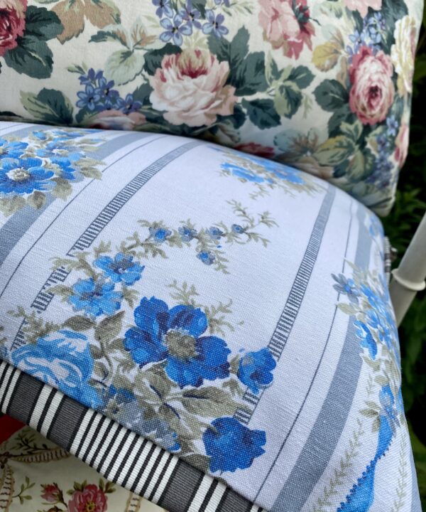 Vintage French floral cushions with a grey, black and white striped Oxford trim.