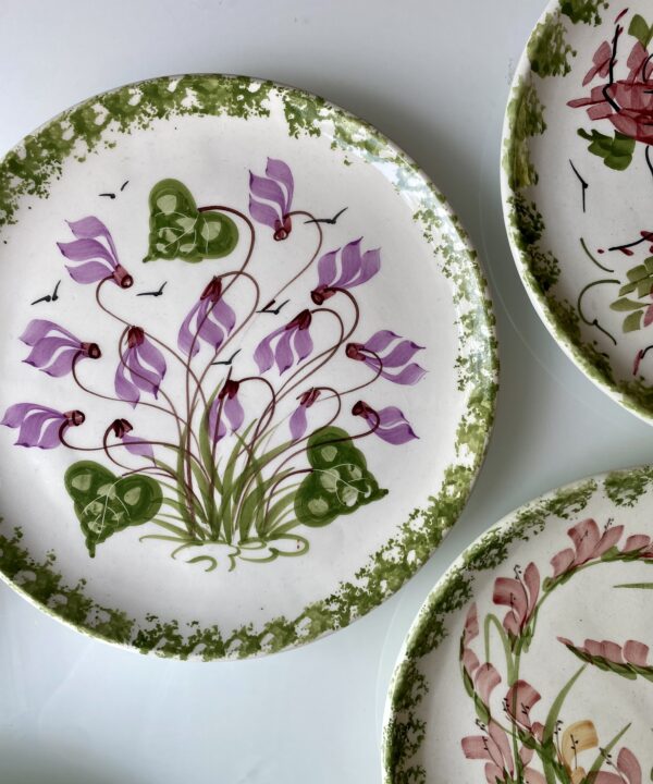 Pretty purple flowers on a vintage wall plate.