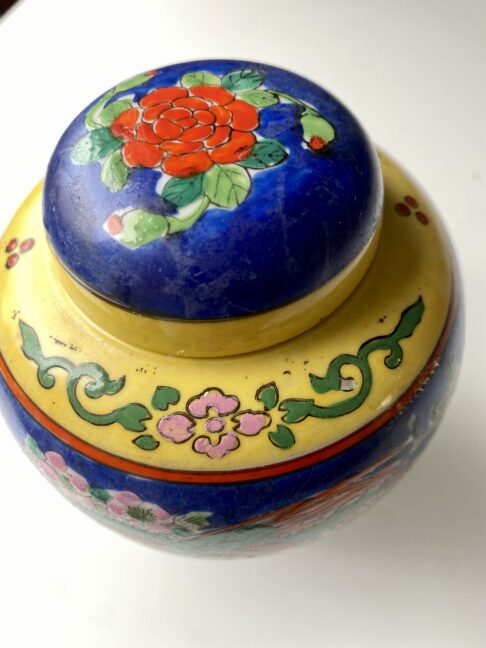 Yellow banding and colourful florals hand-painted on a vintage Japanese jar.