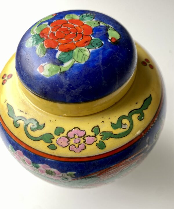 Yellow banding and colourful florals hand-painted on a vintage Japanese jar.